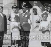 Leonard Mambo Mbotela with wife and family members